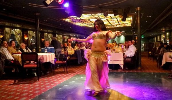 Elegant Nile dinner cruise with illuminated Cairo skyline at night.